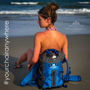 Girl sitting blue backpack seat on the beach