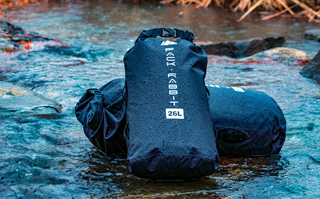 Two dry bags laying in stream